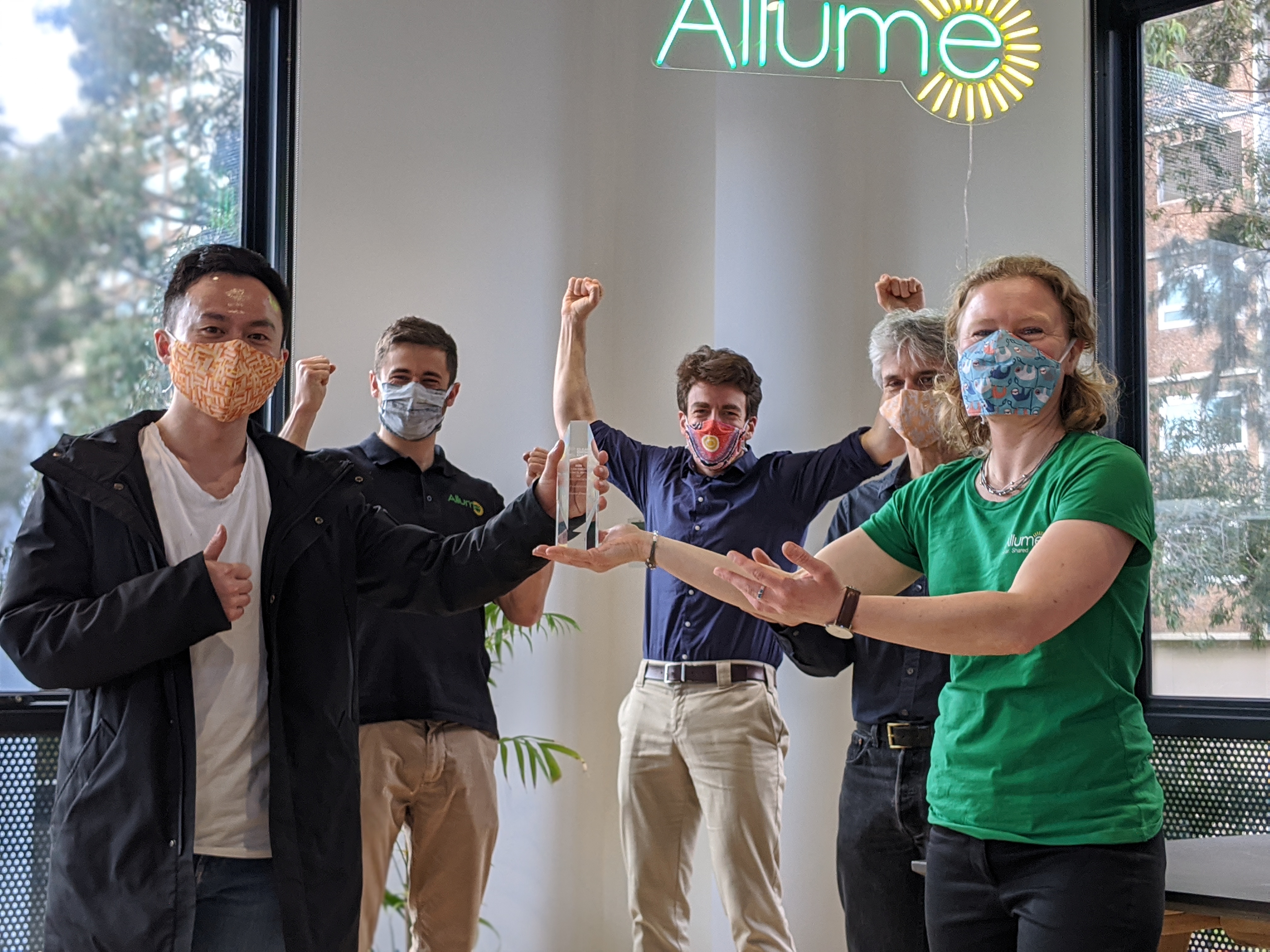 Allume staff holding the CEC trophy